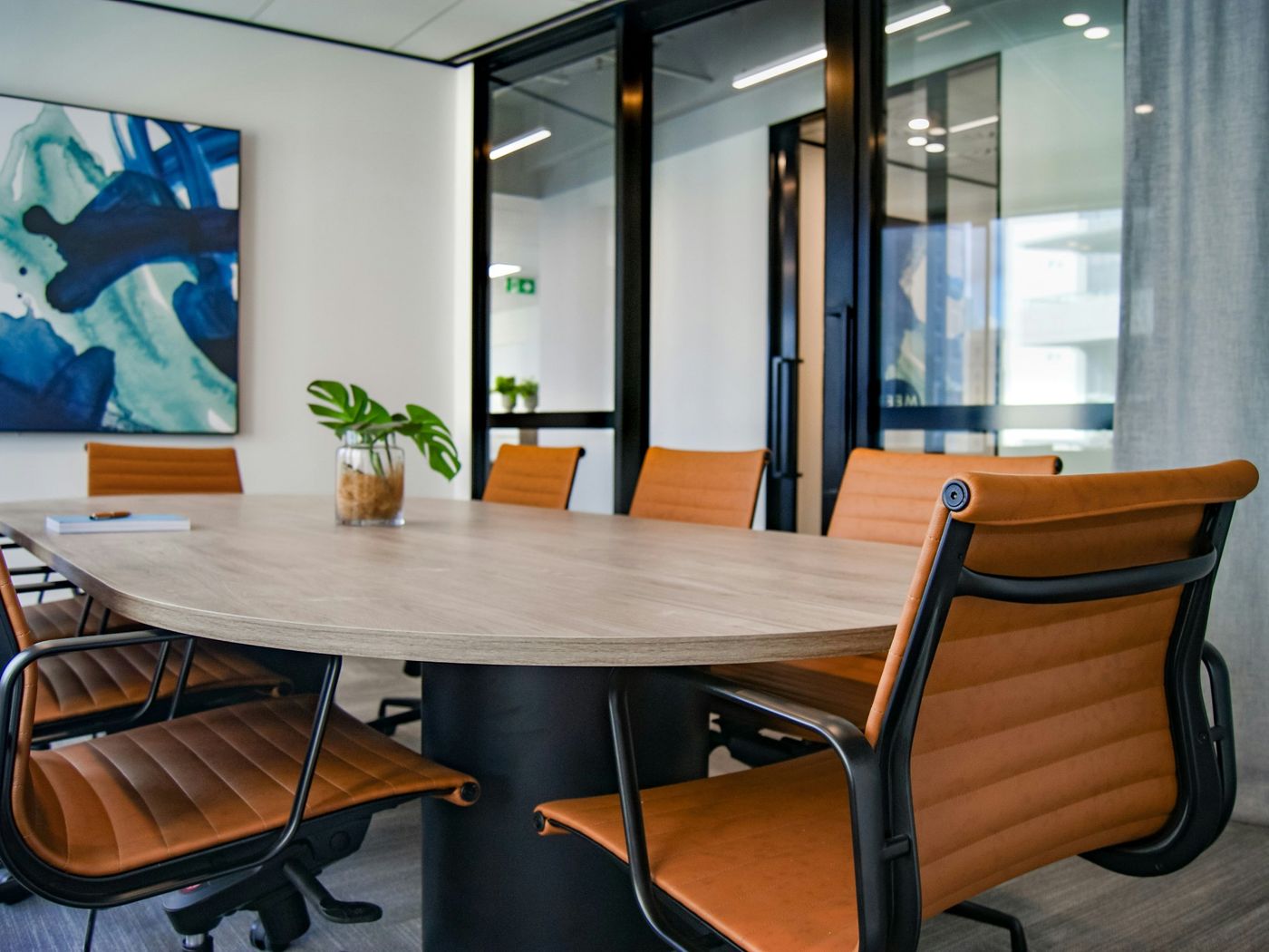 Boardroom with a wooden table and leather chairs