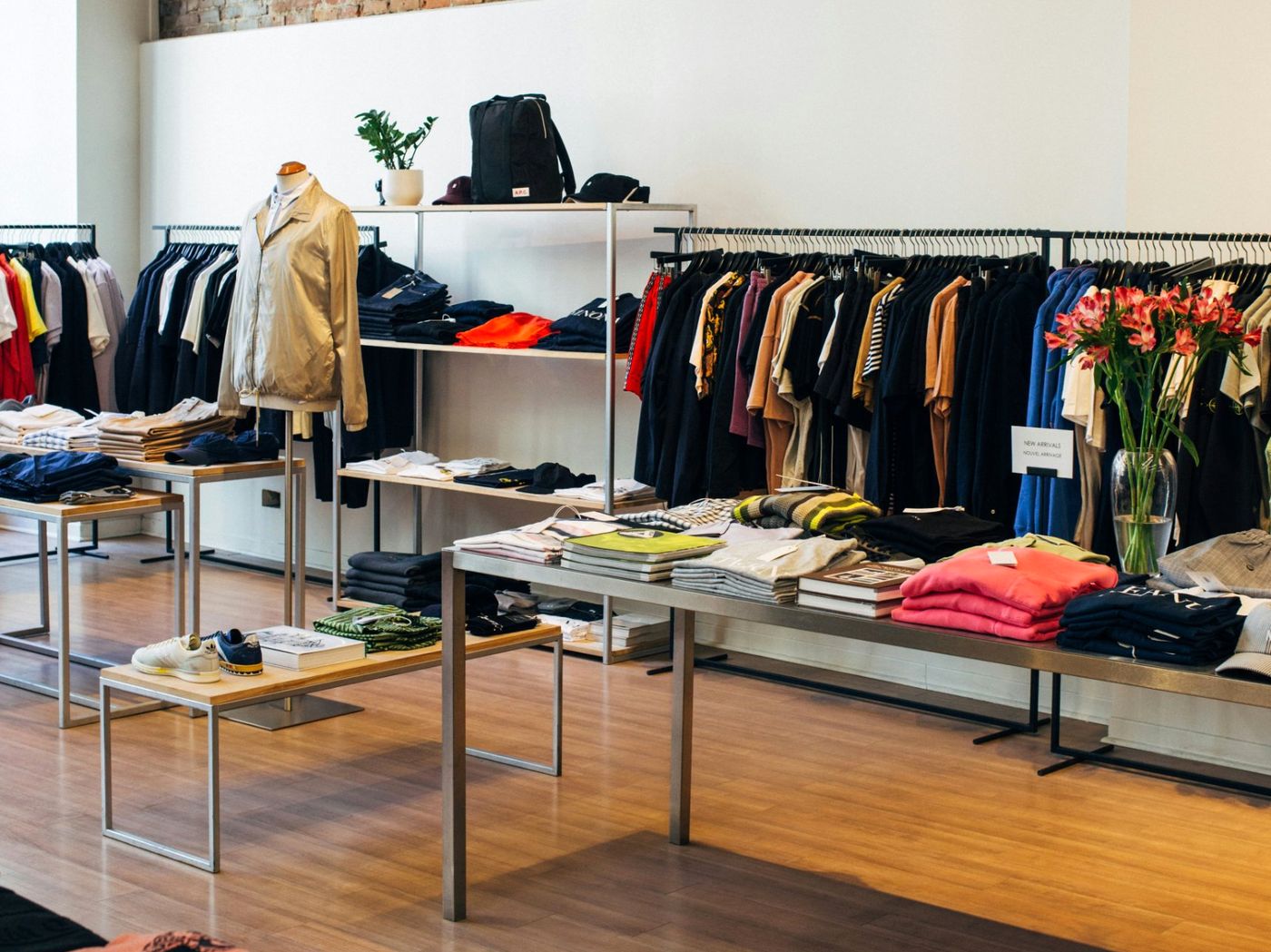 Retail shop interior with clothing rails and display tables