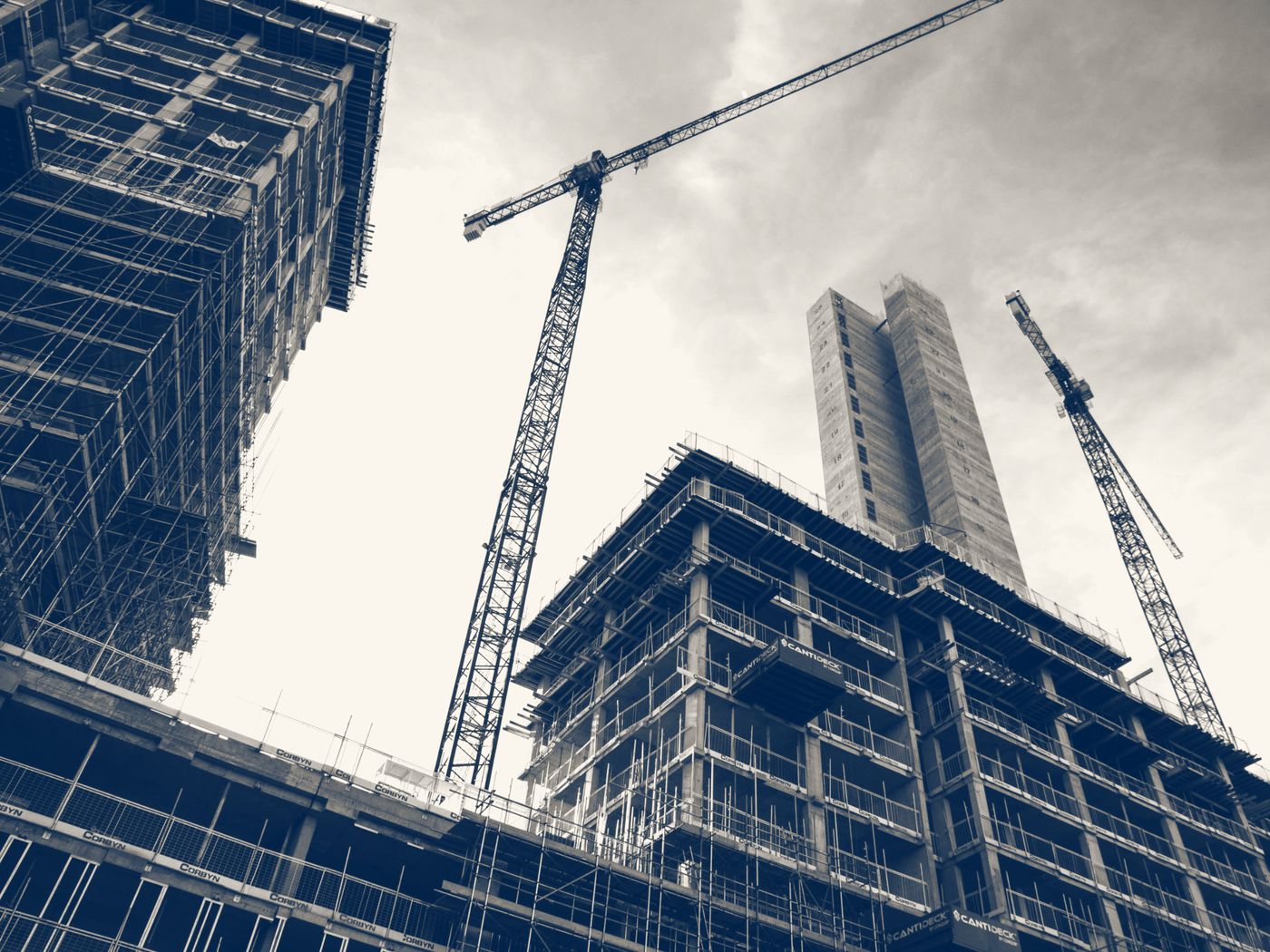 Tower cranes above new buildings under construction