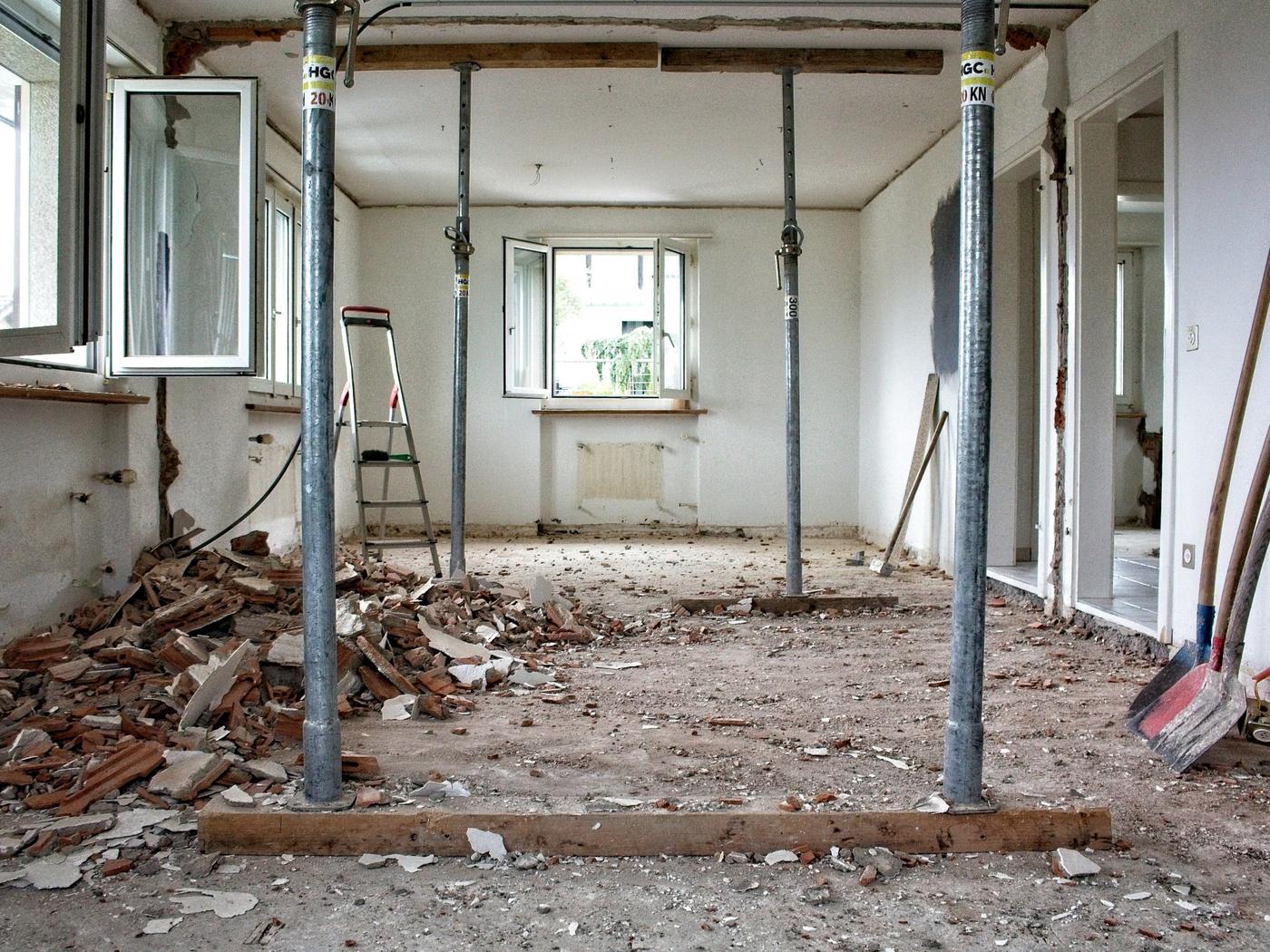 Room stripped back with steel props supporting the ceiling during structural works