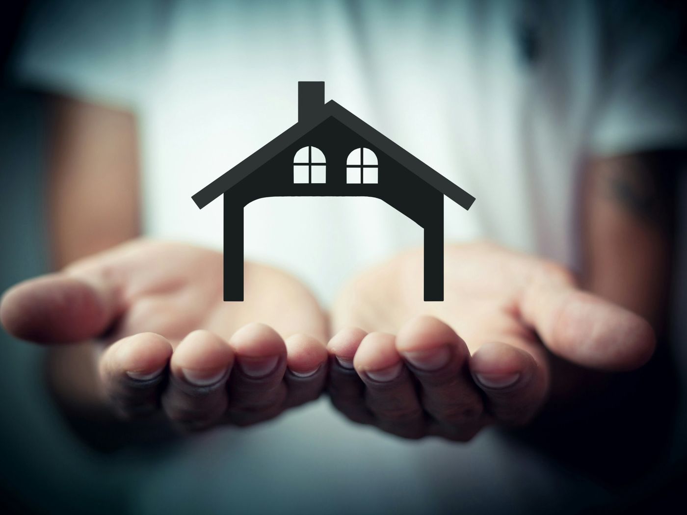 Open hands holding a house symbol