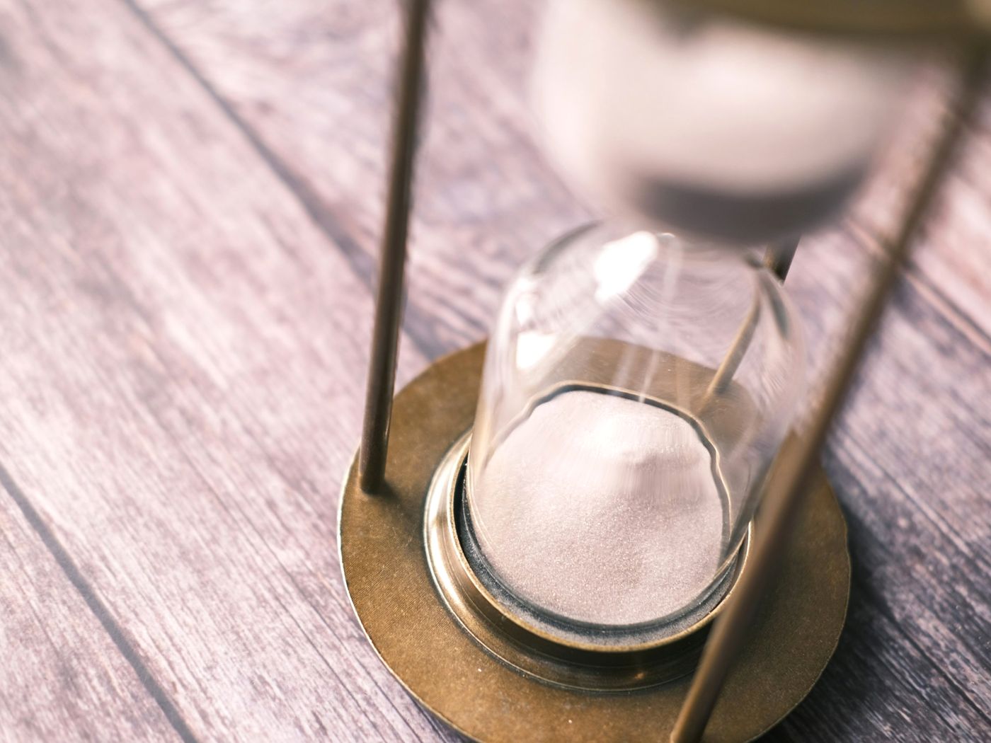 Sand running through an hourglass